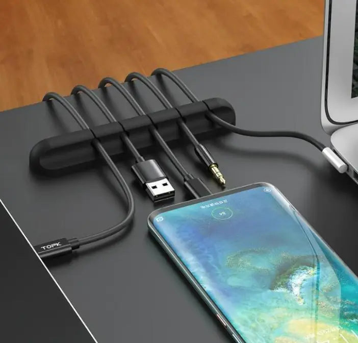 Silicone cable clips holding cables on a desk