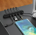 Silicone cable clips holding cables on a desk